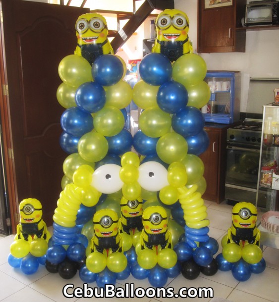 Columns with two-eyed Minions, Centerpieces with one-eyed Minions, & Cake Arch