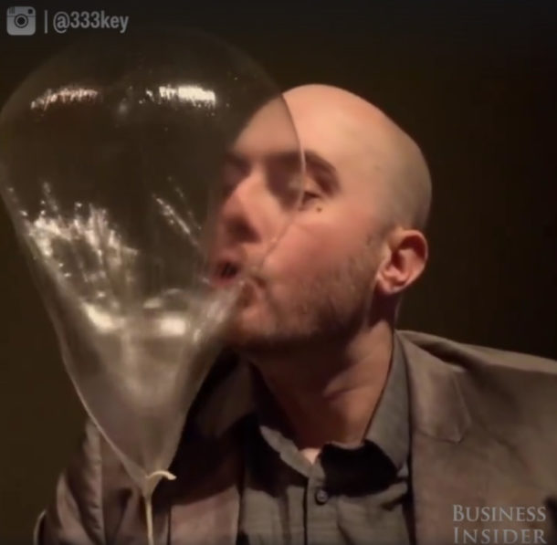 A guy sucking the Helium from the Edible Balloon by @333key