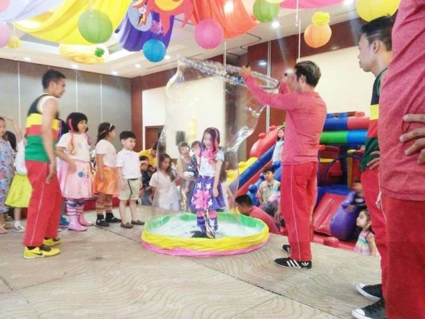 Little girl inside big bubble during birthday